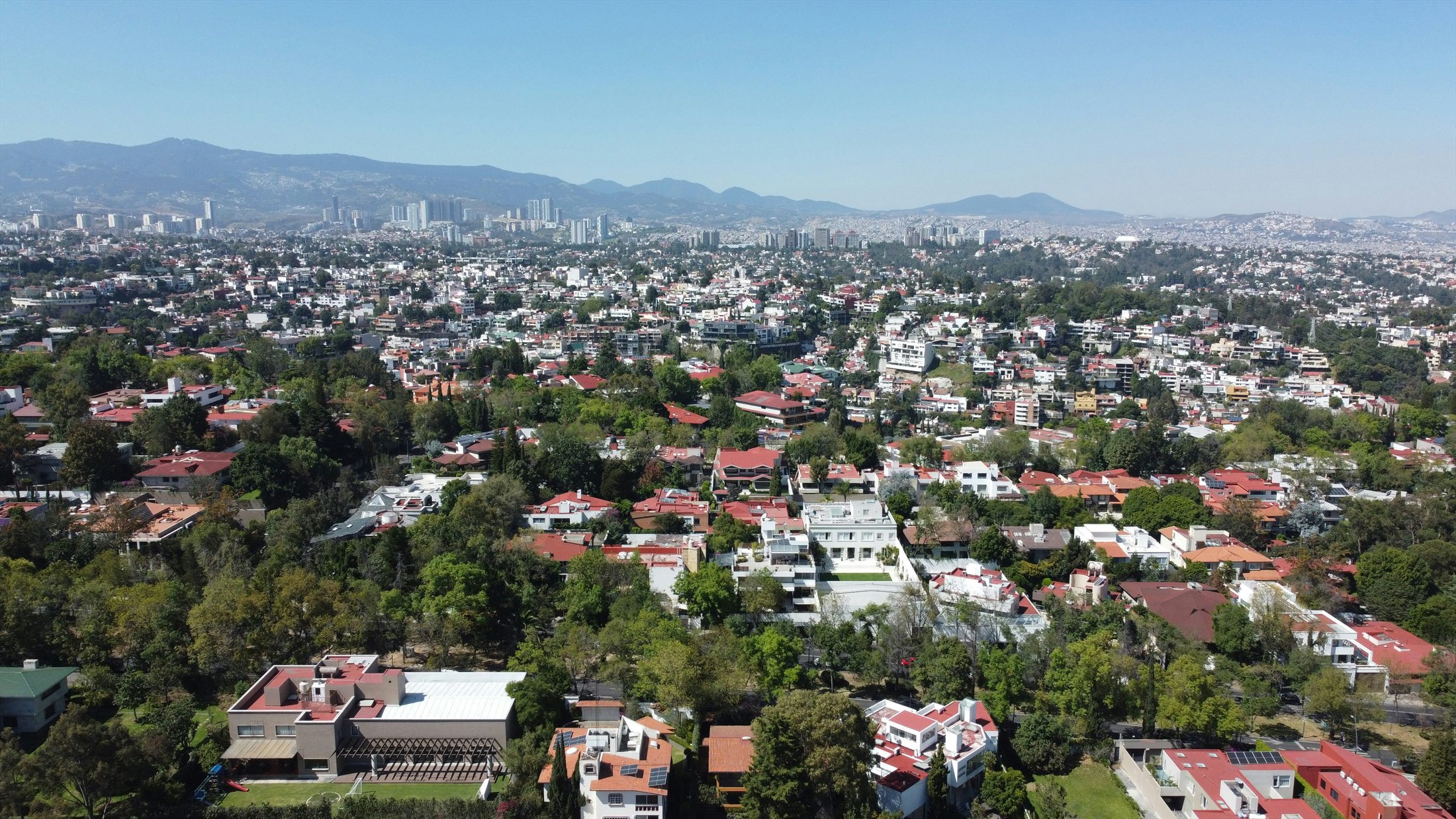 Mexico City seen across dense buildings and mountains