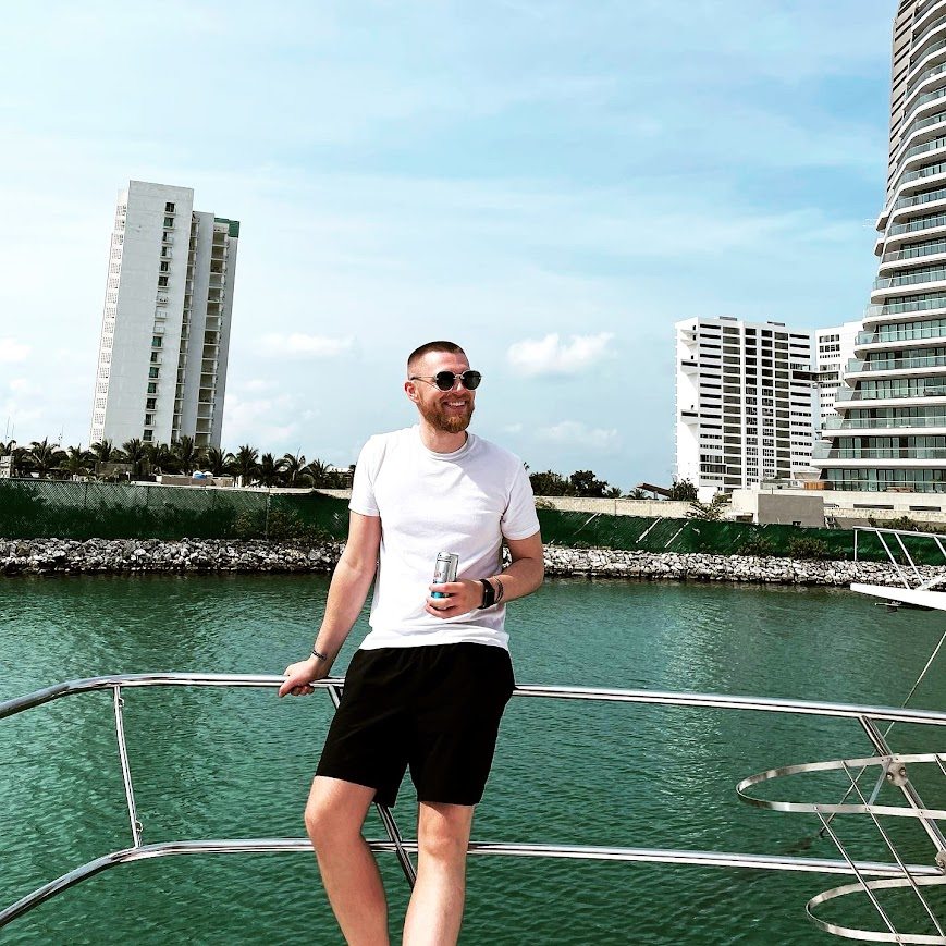 The Bad Digital Nomad standing on a boat in a marina