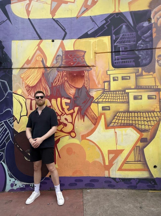 The Bad Digital Nomad standing in front of a street mural